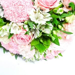 Elegant arrangement of pink roses and white lilies with lush greenery.